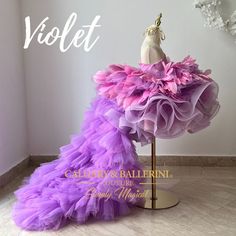 When it comes to birthday dresses, more is definitely more. That's why this couture violet mink dress is perfect for a birthday party. Knee length and off the shoulder, the stunning dress catches eyes with its feather skirt details and striking horsehair braid trim on the skirt. Not only will it make you stand out in a crowd, but wearing such quality materials will assure your birthday look won't be forgotten. From the fur-like texture to the intricate feathers and braid patterns, this birthday Purple Tulle Pageant Dress, Purple Tulle Dress For Pageants, Purple Ruffled Gown For Pageant, Feather Trim Tulle Dresses For Pageants, Purple Ruffled Ball Gown For Pageant, Purple Ruffled Ball Gown For Pageants, Tulle Pageant Dress With Ruffles For Fancy Dress, Purple Ruffled Pageant Dress, Dresses With Feathers