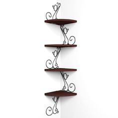 three tiered shelfs with hearts on them against a white wall in an empty room