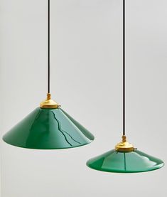 two green lamps hanging from the ceiling