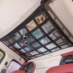 the inside of a vehicle with various items in it's back pocket and hanging from the ceiling