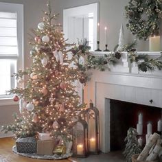 a decorated christmas tree in front of a fireplace