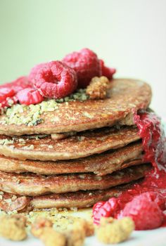 a stack of pancakes with raspberries on top