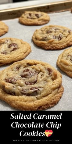 salted caramel chocolate chip cookies on a baking sheet with the words salted caramel chocolate chip cookies