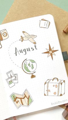 an open notebook with doodles on it and some travel related items around the page