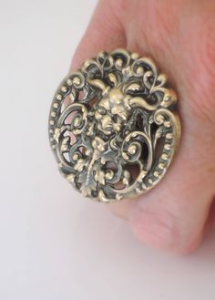 "Vintage Ring - Green Man Jewelry - Pan Ring - Devil Ring - Goth Ring - Celtic Jewelry - Fantasy Jewelry - Brass Jewelry - handmade jewelry This is such an awesome ring! A fabulous vintage brass stamping of Pan. Remarkable detail with a rich patina. This ring is adjustable. Chloe says, \"Wear it and feel fabulous!\" The ring measures 1 3/4\" round. Thanks for visiting Chloe's" Handmade Gothic Ring As A Collectible, Handmade Gothic Gold Ring, Handmade Victorian Metal Rings, Handmade Adjustable Vintage Skull Ring, Vintage Hand Cast Skull Ring As Gift, Vintage Hand-cast Skull Ring For Gift, Vintage Nickel-free Skull Ring For Gift, Vintage Nickel-free Skull Ring Gift, Handmade Vintage Skull Ring