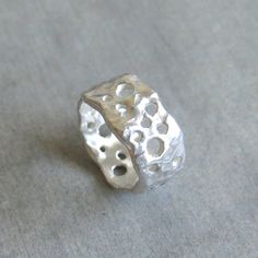 "This delicate organic shaped ring/ band is fully handmade of solid sterling silver with randomly arranged holes of different sizes. The irregular molten texture catches the light and sparkles. The model of each ring is carefully handmade of wax and cast in my home studio's foundry. The ring is elegant, not too chunky on the finger and very comfortable to wear. It is a sturdy, lasting piece of jewelry.  This gorgeous ring ring is ideal for everyday wear and it will also look amazing with a festi Chunky Statement Jewelry, Wax Silver Jewelry, Silver Ring Chunky, Silver Handmade Ring, Organic Silver Jewellery, Art Clay Silver Ring, Wax Cast Ring, Silver Clay Ring Ideas, Silver Ring Handmade