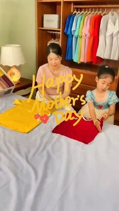 a woman and child sitting on a bed in front of a happy new year card