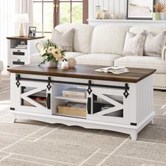 a living room with a white couch and wooden coffee table in front of a window