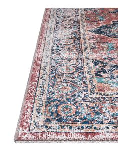 an area rug with various colors and patterns on the floor, including red, blue, pink