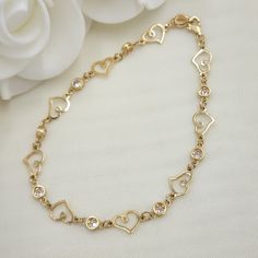 Modern solid 14k Hearts and round cz bezel bracelets. Perfect for everyday and every occasion. Elegant, modern and everlasting. 14k gold will not tarnish or rust. Materials: Solid 14k gold, clear zirconia diamonds. Lenght and weight:  8 inches - 4.9 grams (Weight are an approximate number) Stone size: 4mm. Hearts size: 7×10mm. 14k stamped.   Brand new. 💓 Briza Collections is a small family owned business that works hard on providing the best selection of Fine Solid Gold Jewelry for the best pri Gold Heart Bracelet With Diamond Accents For Gift, Valentine's Day Gold Bracelets With Diamond Accents, Gold Heart-shaped Diamond Bracelet With Accents, Gold Heart-shaped Diamond Bracelet With Diamond Accents, Gold Heart Jewelry With Bezel Setting, Gold Diamond Bracelet With Heart Shape And Diamond Accents, Gold Cubic Zirconia Heart Bracelet For Valentine's Day, Elegant Hypoallergenic Heart Bracelet For Anniversary, Elegant Gold Heart Bracelet With Diamond Accents