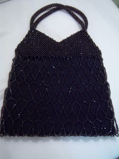 "Black diamond pattern beaded purse was made in Barcelona, Spain and measures 15\" tall including handles x 10\" wide x 1\" deep lying flat. This purse is lined in black silk and is in excellent condition. Secure clasp. Perfect as an accessory for any formal or special occasion." Elegant Black Beaded Rectangular Evening Bag, Elegant Rectangular Black Beaded Evening Bag, Elegant Evening Bag With Black Beads For Party, Elegant Evening Bags With Black Beads, Black Beaded Formal Evening Bag, Elegant Black Beaded Evening Bag For Party, Formal Rectangular Bag With Black Beads, Elegant Black Beaded Evening Bag For Formal Occasions, Black Beaded Evening Bag