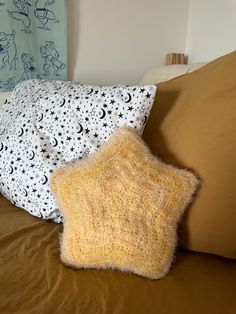 two pillows sitting on top of a bed next to each other