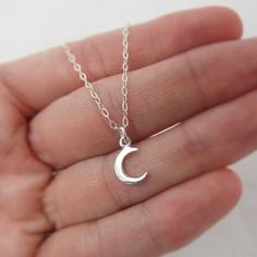 ALL STERLING SILVER - A GREAT KEEPSAKEThis celestial necklace is lovingly hand-made with all solid sterling silver parts, making it a thoughtful gift (even for yourself!). A tiny moon dangles elegantly from the sparkly chain. Closes with an easy-to-use spring clasp. Moon charm measures approximately 3/8 inch tall. Comes in a gift box, perfect for gift-giving. **SIZING - PLEASE READ:Select your necklace size at checkout. Note that necklaces will fit differently depending on a person's size. Pleas Dainty Silver Moon Charm Necklaces, Silver Moon Charm Necklace For Gift, Silver Crescent Sterling Silver Charm Necklace, Dainty Silver Moon Charm Necklace, Dainty Silver Moon Shaped Jewelry, Silver Dainty Moon Charm Necklace, Sterling Silver Moon Charm Necklace For Gift, Celestial Sterling Silver Necklaces As A Gift, Celestial Sterling Silver Necklace Gift