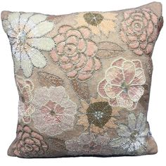 a decorative pillow with flowers on the front and back, made from sequins