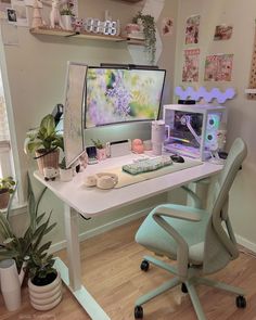 a desk with a computer monitor, keyboard and mouse on it next to potted plants