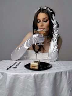 a woman sitting at a table with a piece of cake