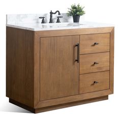 a bathroom vanity with two faucets on the top and one sink below it