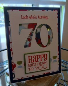 a 70th birthday card with the number seventy on it, sitting on top of a table