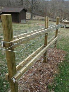 a wooden fence in the middle of a field