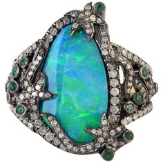 This ring has been meticulously crafted from 18-karat gold & sterling silver. Handcrafted in 5.04 carats opal doublets, .25 carats Emerald & illuminated with 1.0 carats diamonds. The ring is a size 7 and may be resized to larger or smaller upon request. FOLLOW MEGHNA JEWELS storefront to view the latest collection & exclusive pieces. Meghna Jewels is proudly rated as a Top Seller on 1stDibs with 5 star customer reviews. All items manufactured by us are handmade and can be customized or redesigne Luxury Opal Rings With Gemstones, Luxury Opal Ring With Diamond And Gemstone Accents, Luxury Diamond Opal Ring With Gemstone Accents, Luxury Opal Ring With Cabochon Cut, Luxury Opal Ring With Gemstone Accents For Anniversary, Luxury Opal Cabochon Rings, Luxury Opal Rings With Gemstone Accents, Luxury Collectible Opal Gemstone Ring, Unique Diamond Opal Ring For Formal Occasions