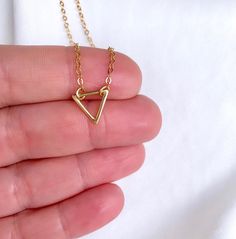 Dainty Gold Filled Triangle Pendant Necklace --- International Customers: Please be familiar with your country's policies in regards to customs fees prior to purchasing overseas. Any fees/taxes are the buyer's responsibility and may be charged at the time of delivery/pick-up. This is not included in the costs here. Thank you! Add the perfect minimalist look to any outfit with this dainty necklace. Features a mini Gold Filled Triangle Pendant adorned on a Gold Filled Link Chain. These look beauti Elegant Triangle Necklace For Gifts, Small Minimalist Necklace As A Gift, Small Minimalist Necklace Perfect For Gifts, Small Minimalist Necklace For Gift, Minimalist Small Necklace Perfect For Gifts, Nickel-free Minimalist Necklace, Small Minimalist Nickel Free Necklace, Minimalist Nickel-free Necklace, Triangle Necklace With Adjustable Chain For Gift