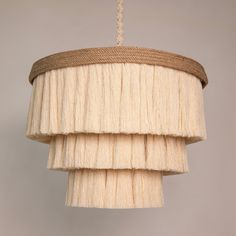 a light that is hanging from a ceiling with some kind of fringe on top of it