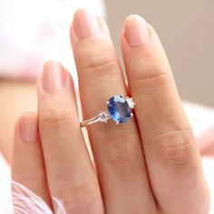 With a brilliant cut like that, this ring is nothing but pure brilliance in itself. With a lovely Kyanite, the Khloe ring with two side moissanite sparkles like there is no tomorrow. Celebrate your milestones or special occasions with this ring as the perfect gift for sisters as a best friend's gift, or just as an everyday celebration of life in general. Details: Center stone Gemstone: Kyanite Stone Shape: Oval Measurements: approx. 9x7mm Side stones Gemstone: Moissanite Shape: Round Measurement Dazzling Oval Sapphire Promise Ring, Oval Lab-created Sapphire Diamond Ring For Wedding, Oval Sapphire Promise Ring With Ethical Diamonds, Dazzling Oval Diamond Promise Ring, Elegant Oval Moissanite Crystal Ring, Oval Sapphire Solitaire Birthstone Ring, Dazzling Oval Sapphire Diamond Ring, Oval Sapphire Solitaire Promise Ring, Oval Topaz And Diamond Proposal Ring