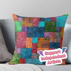 a colorful patchwork pillow with the words support independent artists on it