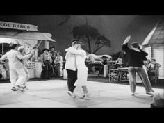 black and white photo of people dancing on the street