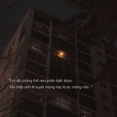 an apartment building lit up at night with the words tu nin cant they'd long chest or dur