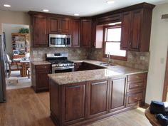 a kitchen with wooden cabinets and granite counter tops