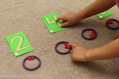 a child playing with numbers and magnets on the floor