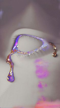 a close up of a pair of eye lashes with water droplets on it's side