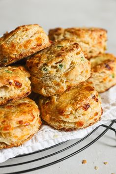 some biscuits are sitting on top of a white paper towel next to a wire rack