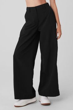 Think of these pants as a cross between cargos and trousers: The fabric is swishy and voluminous (a nod to the ’90s) but the finishes are utterly classic (peep the pockets, belt loops and tailored front). Fitwise, they have an extra high rise, wide legs and a stretchy-back elastic waist for a perfect fit every time. Complete your it-girl look with a crop top and cute loafers. Alo Trousers, Alo Yoga Wide Leg Pants With Elastic Waistband, Alo Yoga High Stretch Full-length Bottoms, Alo Yoga Elastane 4-way Stretch Bottoms, Black Wide-leg Sweatpants With Elastic Waistband, High Waisted Flare Pants, Street Smart, Smart Trousers, Trouser Pants Women