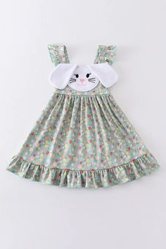 Green Easter Floral Print Bunny Applique Dresses Hop into spring in style with our Green Easter Floral Print Bunny Applique Dress! This adorable dress features a fun and playful bunny applique on a beautiful green floral print. Perfect for Easter brunch or any springtime event, this dress is sure to make a statement. (And make your little one even more egg-cited for the holiday!)  Super soft & stretchy!  Cotton/Spadex blend. 95% Cotton 5% Spandex Check out all our listings as we do combine shipping! Spring Cotton Dress With Floral Applique, Spring Floral Applique Beach Dress, Whimsical Spring Dresses With Floral Applique, Spring White Cartoon Print Dress, Spring Beach Dress With Floral Applique, White Cartoon Print Dress For Spring, Fun Sleeveless Spring Dress, Playful Sleeveless Easter Dress, Playful Easter Dresses For Playtime