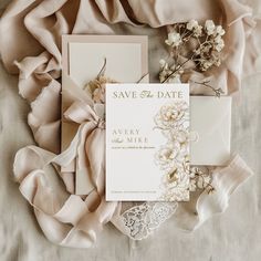 an elegant wedding suite with lace, flowers and satin ribbons on a bed sheet in front of a silk scarf