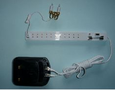 an electronic device is plugged into the wall with two wires attached to each side