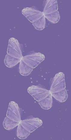 three purple butterflies flying in the sky