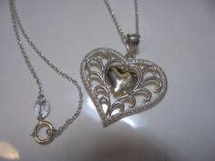 1  in. INCLUDING BAIL  sterling silver  HEART  pendant with  SOLID 10 KT SMALL CENTER HEART PENDANT   MARKED 925 / 10KT  ,   18 IN. LONG STERLING SILVER CHAIN SPRING CLASP  , great condition.  Thanks Gold Heart-shaped Jewelry Stamped 925, Gold Heart Jewelry Stamped 925, Silver Hallmarked Heart Necklace For Valentine's Day, Silver Heart Necklace For Valentine's Day Formal, Silver Heart Necklace For Valentine's Day And Formal Events, Valentine's Day Silver Heart Necklace Hallmarked, Valentine's Day Silver Hallmarked Heart Necklace, Silver Heart Pendant Necklace For Valentine's Day, Lux Lisbon