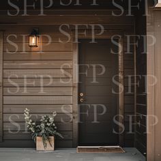 the front door of a house with a potted plant on the porch next to it