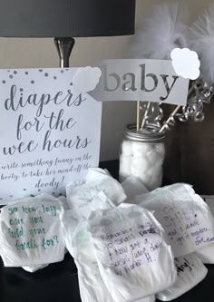 diapers for the wee hours are on display in front of a baby's sign