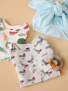 Add some fun to nursery essentials with Tea's soft long sleeve body suit two-pack set. You and your little one will love our new, buttery soft fabric. Fitted with some stretch to keep baby comfy. Easy-to-dress features like an envelope neckline and snap closure make diaper change a breeze.

Vegetable garden and cool chicken prints are hand drawn by our artists in San Francisco. Both prints can be worn solo or easily layered with one of our coordinated outfit sets. Long Sleeve Onesie For Bedtime In Spring, Playful Long Sleeve Onesie For Summer, Printed Long Sleeve Onesie For Bedtime, Playful Long Sleeve Summer Onesie, Long Sleeve Printed Onesie For Summer, Playful Long Sleeve Printed Onesie, Cute Long Sleeve Soft Onesie, Cute Soft Long Sleeve Onesie, Long Sleeve Printed Summer Onesie