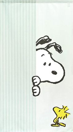 a snoopy dog peeking out from behind a wall