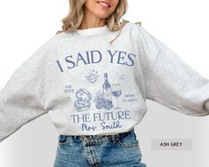 a woman wearing a sweatshirt that says i said yes the future mrs smith