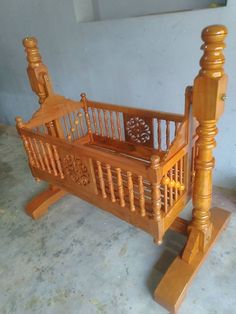 a wooden crib sitting on top of a floor