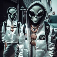 two people in alien costumes are walking down the street, one is wearing a hoodie