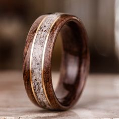 a wooden ring with antler and gold inlays