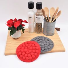 a wooden cutting board topped with spices and utensils