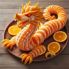 an orange dragon made out of sliced oranges on a brown plate with slices cut in half